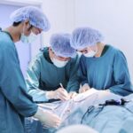 Surgical oncologist discussing cancer treatment plan with medical team in a modern hospital setting