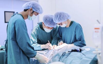 Surgical oncologist discussing cancer treatment plan with medical team in a modern hospital setting